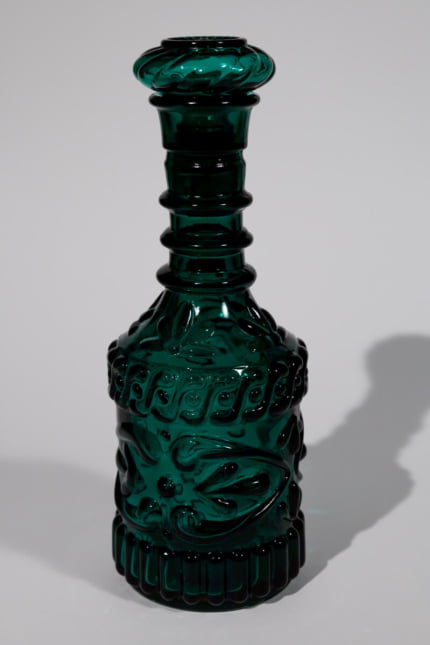 Vintage dark green bottle with lid